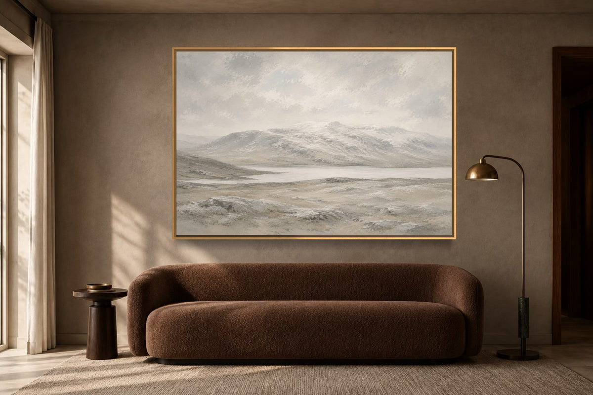Winter Stone pale mountain landscape wall art above a warm brown sofa