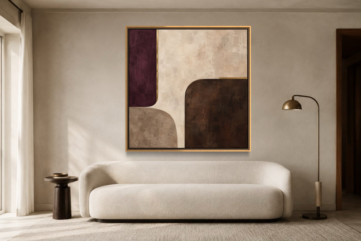 After Plum square plum and neutral abstract wall art above a curved ivory sofa